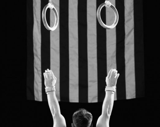 Athlete reaching for gymnast rings