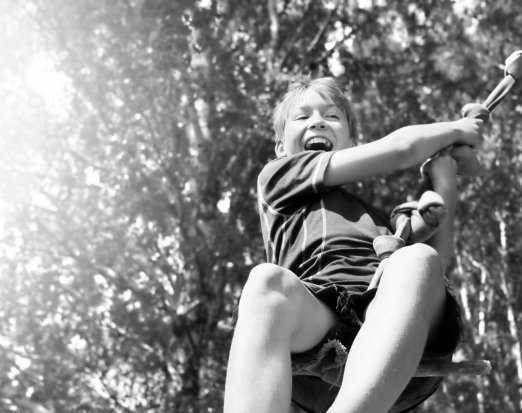 Grinning Child on a Rope Swing