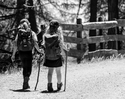 Two Young Girls with Backpacks Going on a Hike