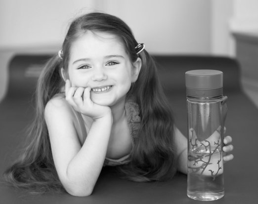 Smiling child holding a water bottle