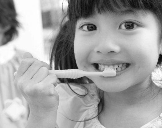 Young Girl Demonstrating Proper Toothbrushing Technique