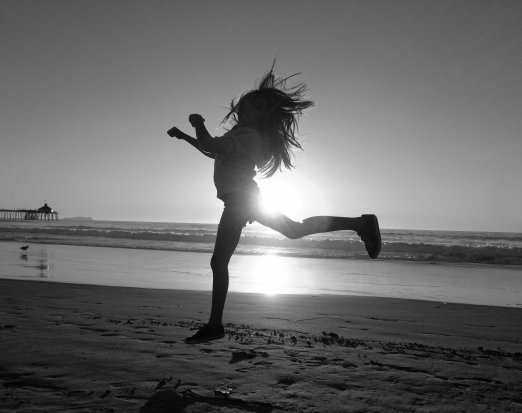 Girl Leaping on a Beach