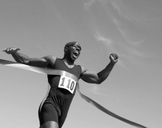 Athlete running through the finish line