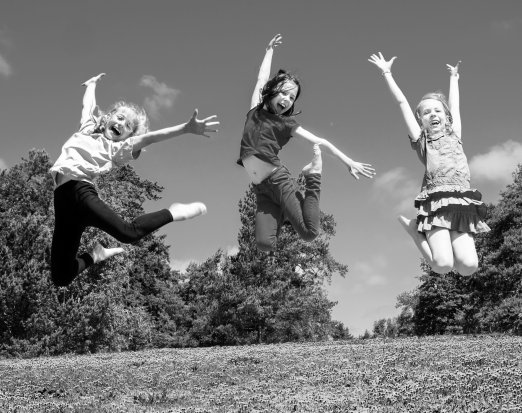 three young girls leaping into the air