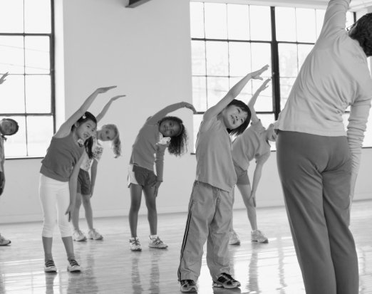 Children Doing Stretches With Their Teacher