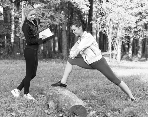 Woman stretching in the woods