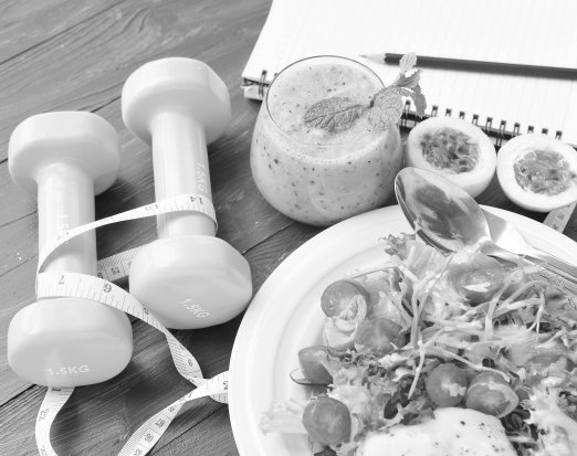 Healthy food and weights on a blue table