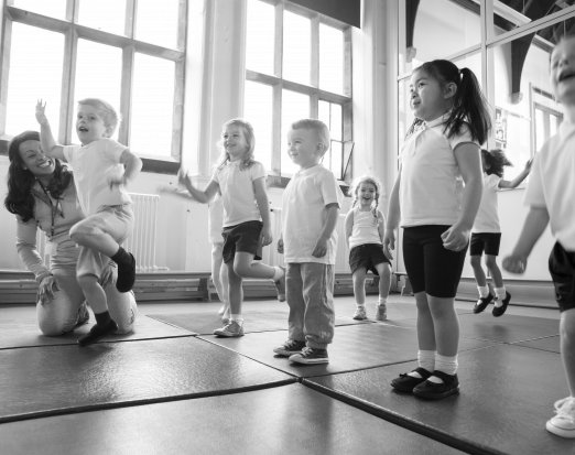 Primary School Pupils Exercising on Gym Mats