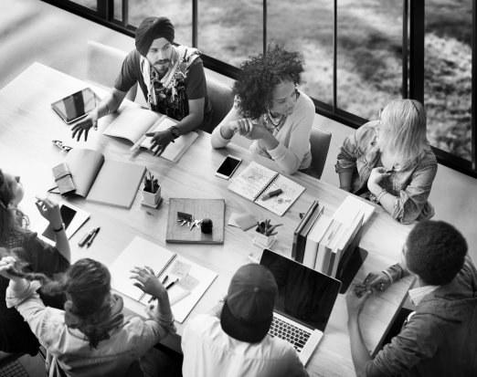 A Group of Teachers Brainstorming At a Desk