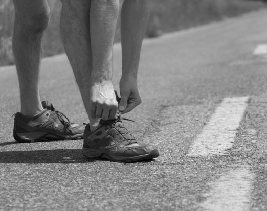 Man tying up running shoes