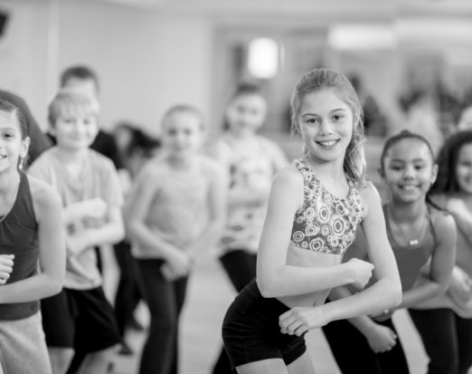 A Group of Children Smiling and Holding a Dance Pose 