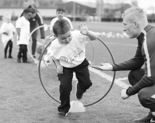 Children Jumping Through Coloured Hula Hoops