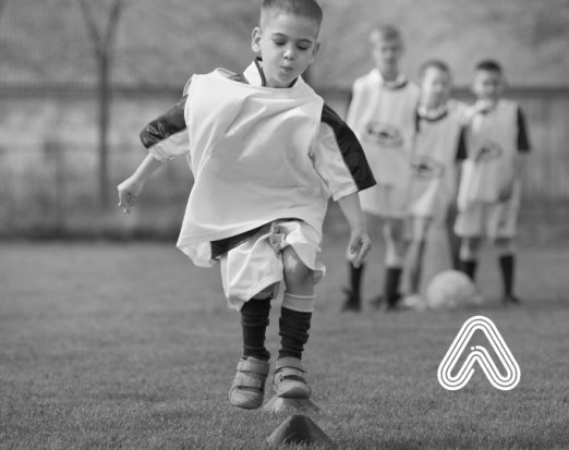Young boy playing football Amaven 