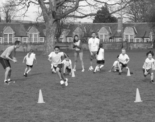 primary school kids playing football